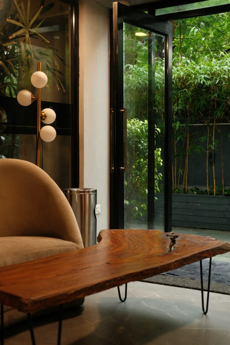 Two people compare samples of eco-friendly flooring and countertop materials at a sunlit kitchen table.
