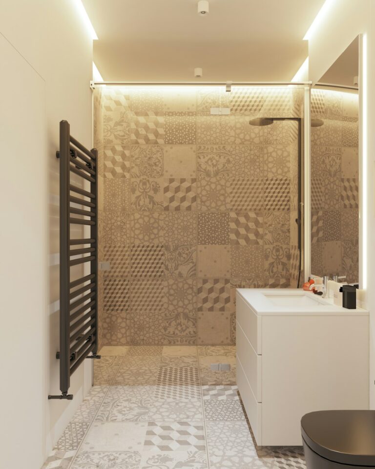 Bright compact bathroom with a floating vanity, large mirror, pale tile, and organized storage.